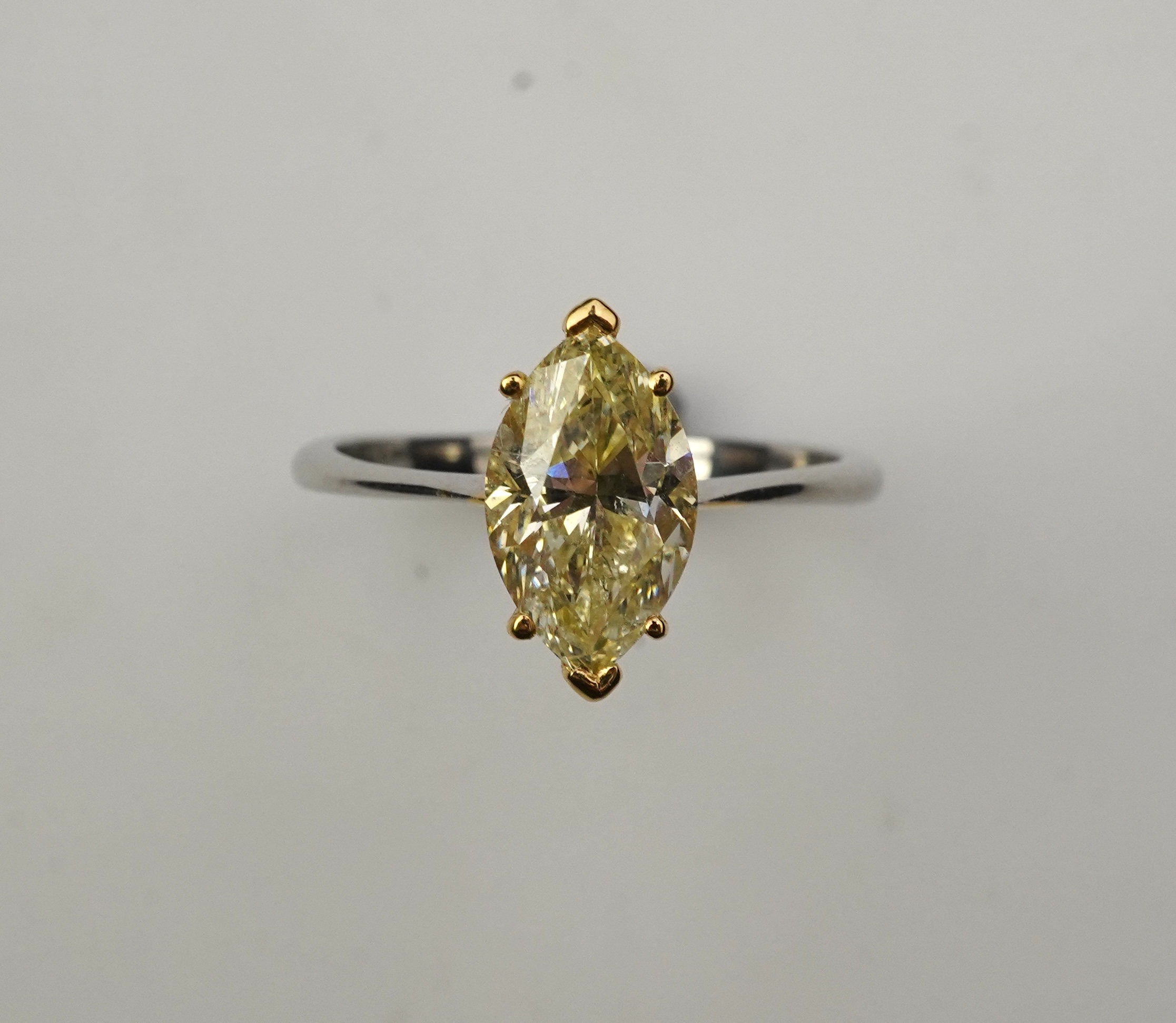 A yellow diamond solitaire ring